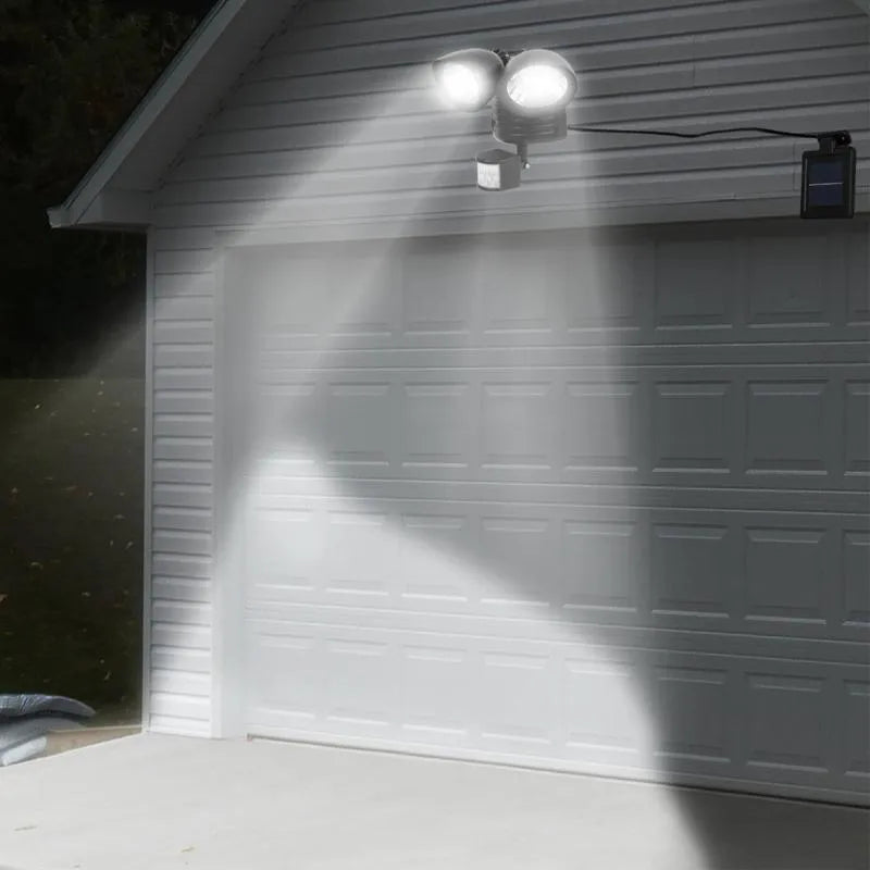 Double head solar induction spotlight in black mounted on a wall with motion sensor and LED light