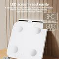 White professional body fat scale with 8 electrodes and LED display on tempered glass platform