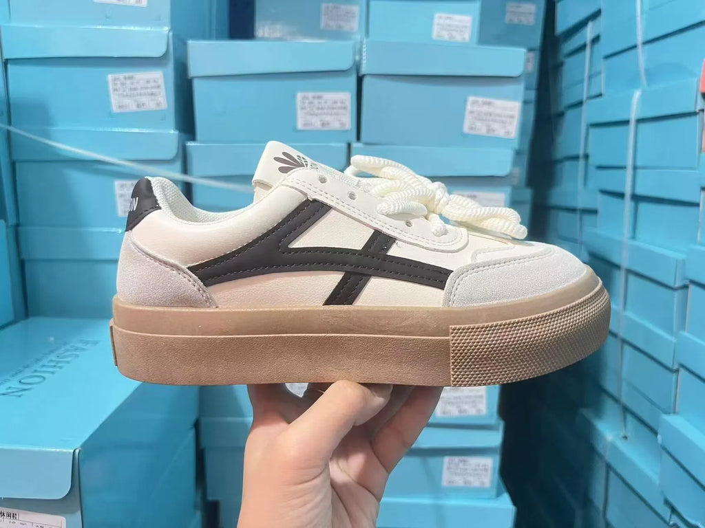Blue and brown low-top women's borad shoes with patent leather upper and flat rubber sole.