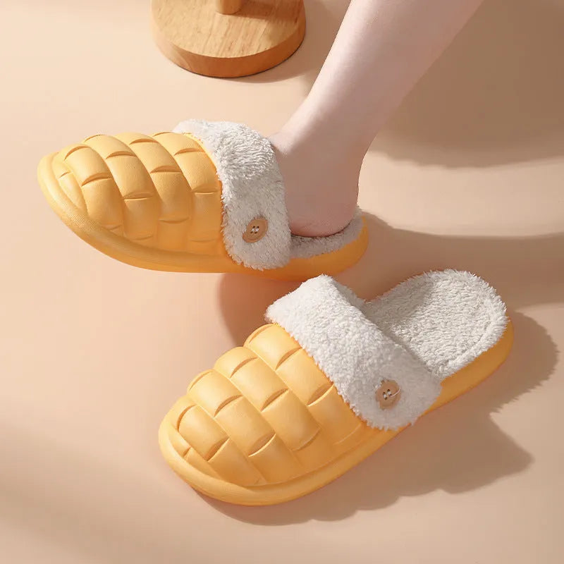 Women's pink and grey plaid EVA slippers with a detachable upper and plush lining on a wooden floor.