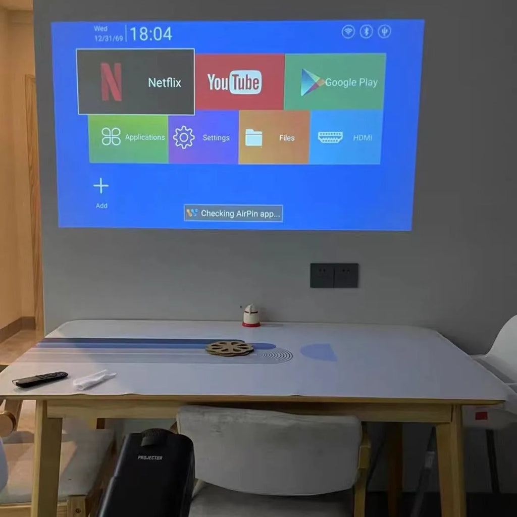 White HD wireless projector with handle showing 720p resolution capability and multi-standard power support for home gaming