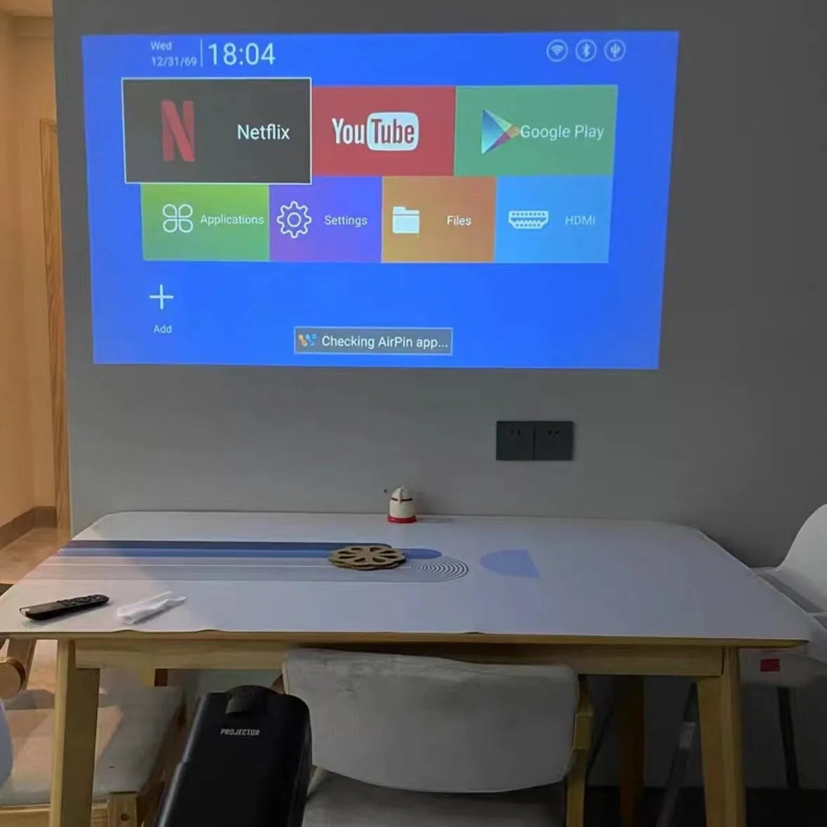 White HD wireless projector with handle showing 720p resolution capability and multi-standard power support for home gaming