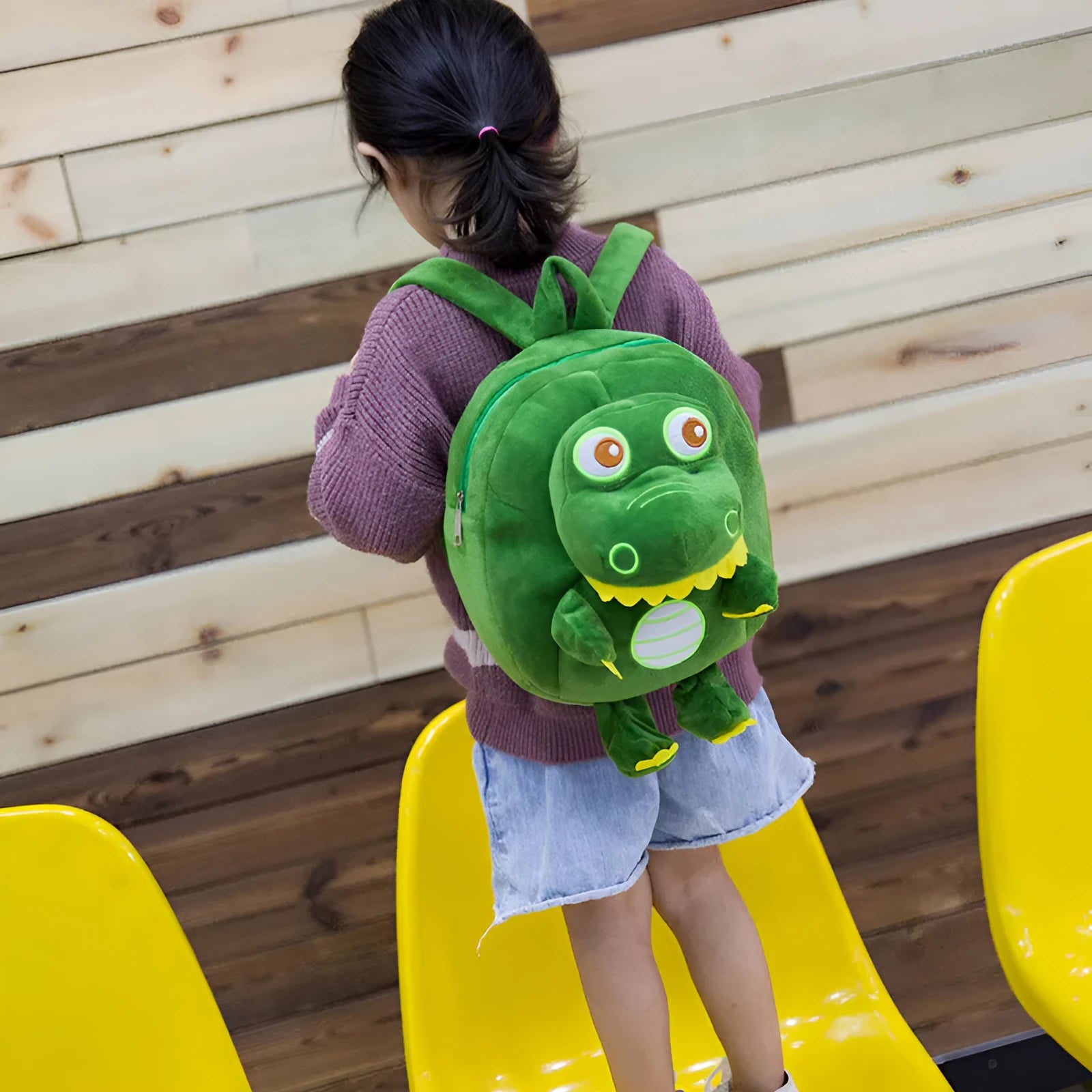 Soft plush baby dinosaur character backpack with embroidery detailing and soft handle