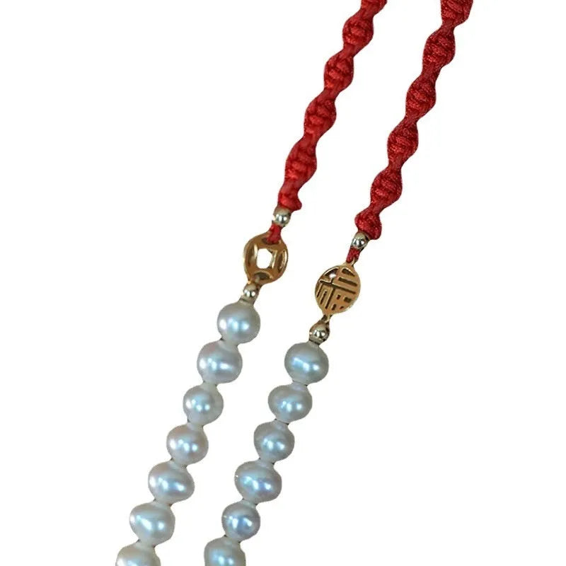 Women's pearl braided red rope bracelet with domestic 14K gold plated fu character charm on red background