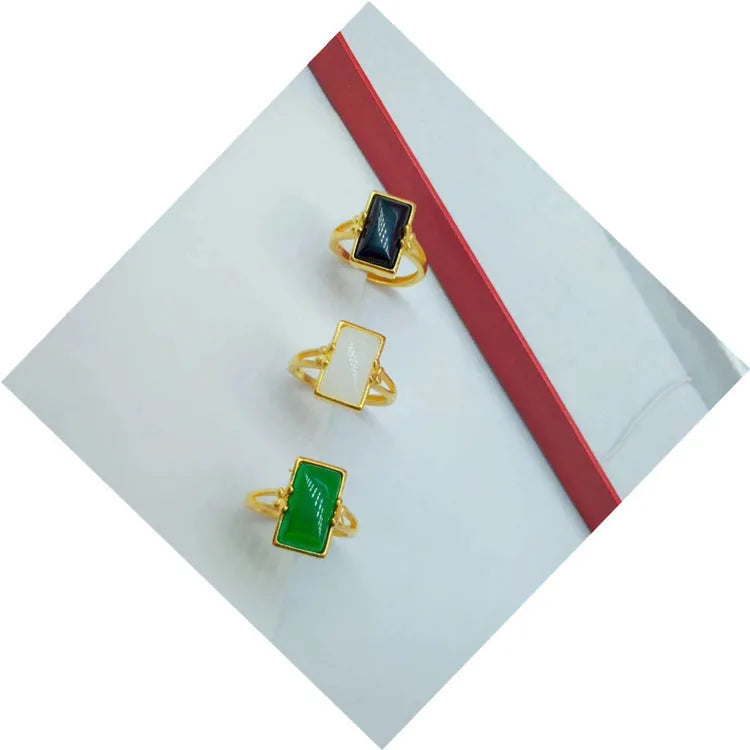 Adjustable brass gold-plated ring with electroplated gemstone inlay showing black, green and white colour options