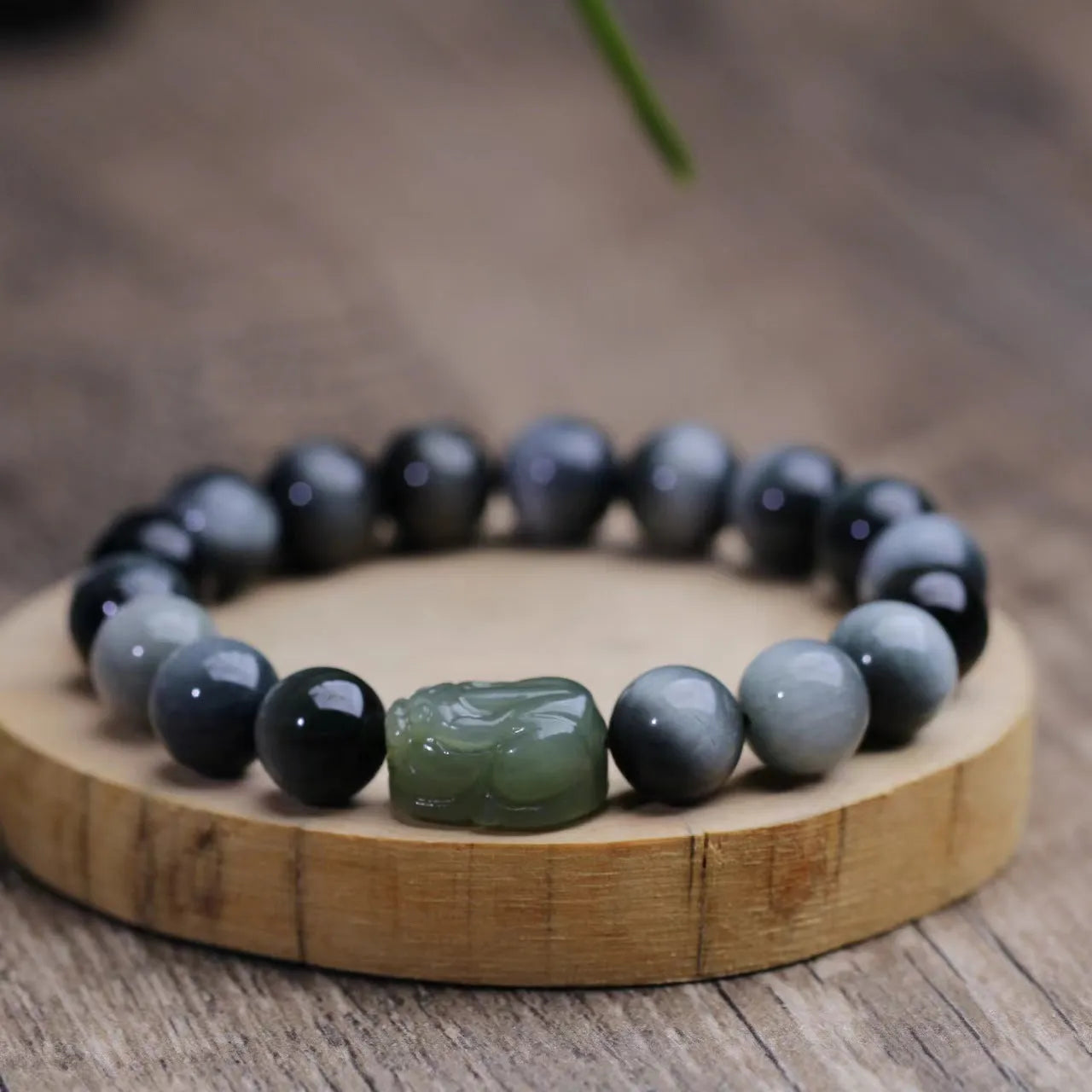 10mm black eagle eye stone and natural Hetian jade clear water Pixiu bracelet on a neutral background