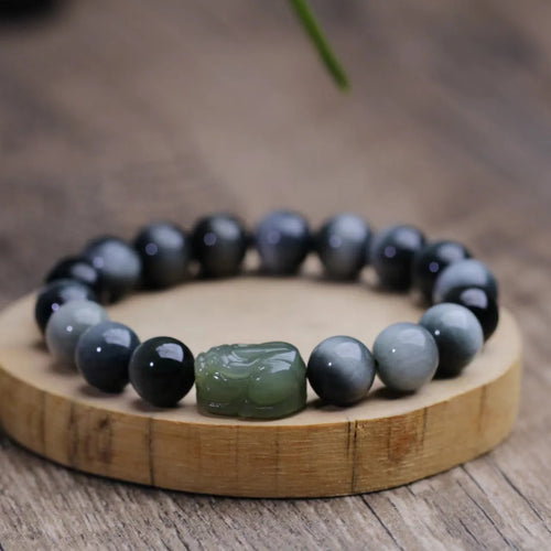 10mm black eagle eye stone and natural Hetian jade clear water Pixiu bracelet on a neutral background