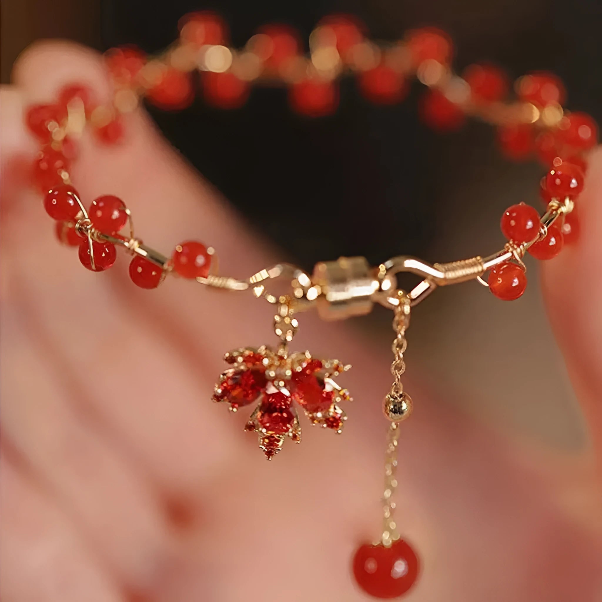 Maple Leaf Girl red ginkgo leaf magnetic bracelet on wrist, electroplated alloy finish
