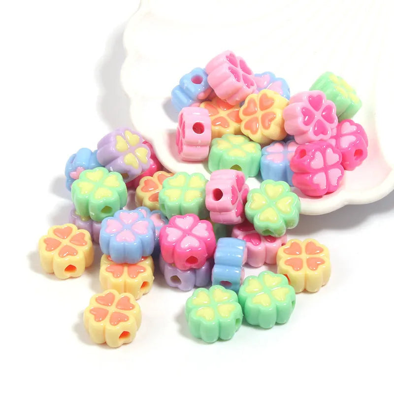 Acrylic four-leaf clover craft beads with love pattern in mixed colours showing frosted finish