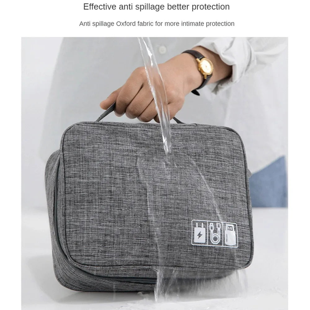 Black travel electronics organiser case with mesh pockets, elastic loops and removable padded dividers