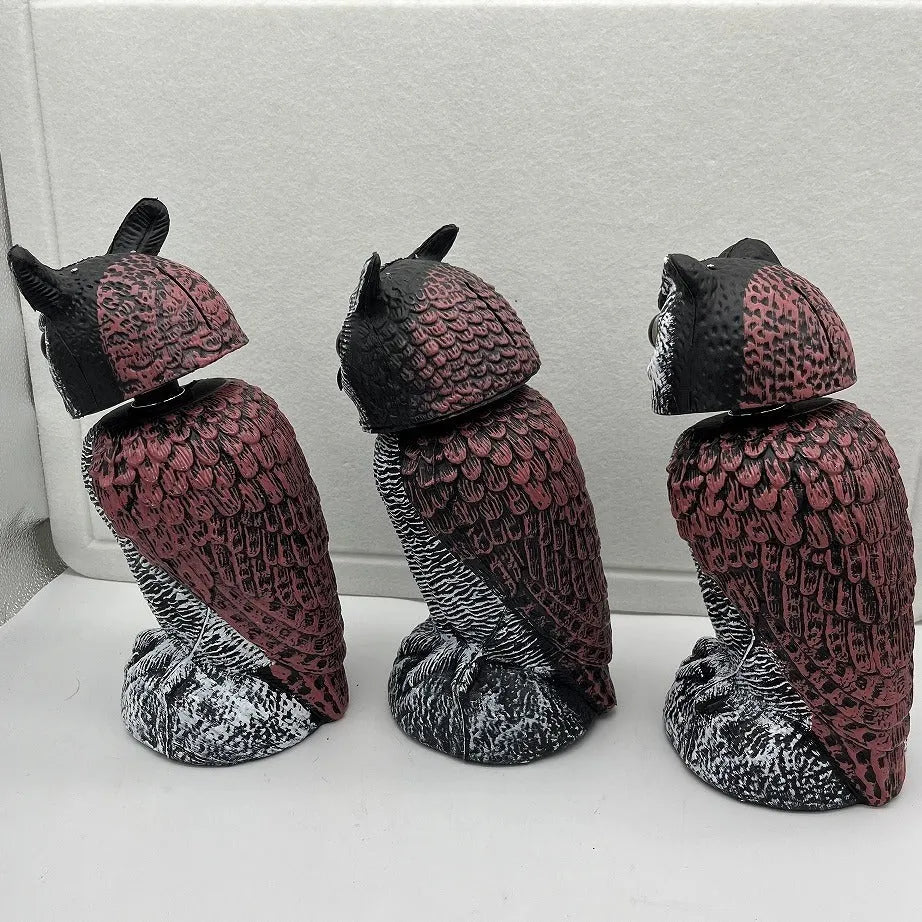 Artificial owl garden ornament with shaking head for bird deterrent on patio