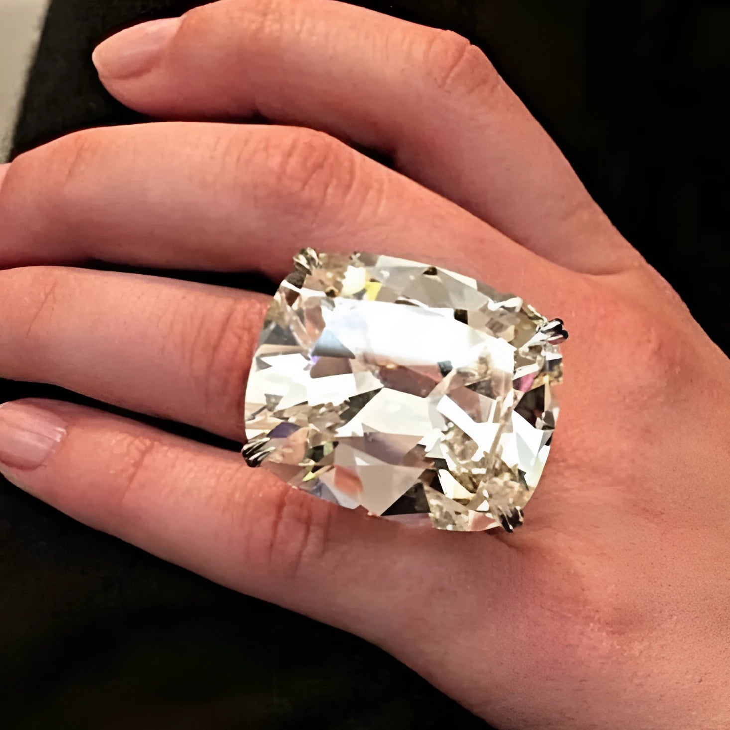 Simple women's ring with an inlaid square diamond design in a white gold colour.