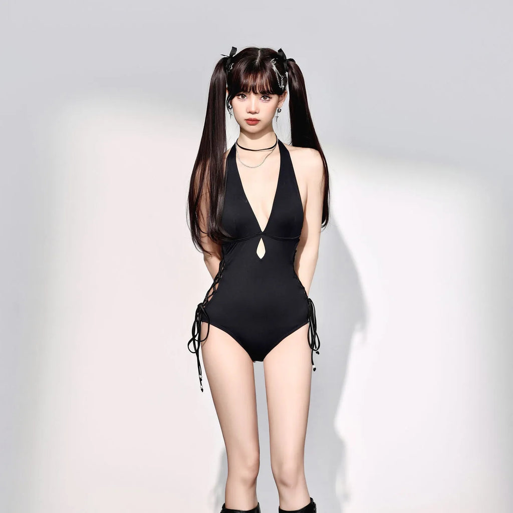 Women's V-neck hollow strap niche one-piece swimsuit in black polyester on a model