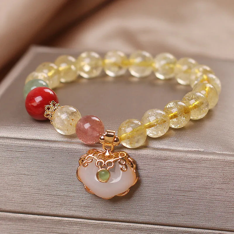 Women's yellow hair crystal jade ruyi pendant bracelet on an alloy chain.
