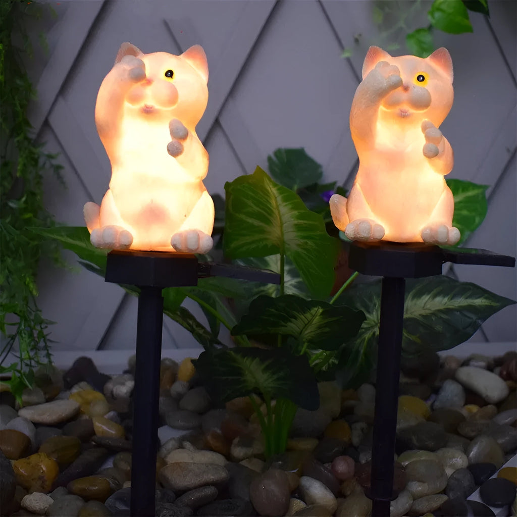 Brown cat-shaped solar-powered LED lawn light on grass