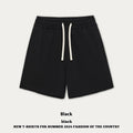 Loose-fit cotton denim shorts for a baby boy or girl in charcoal gray, shown on a size chart.