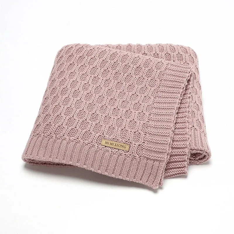 Solid colour acrylic baby blanket with textured lines, shown in a neutral shade, dimensions 70x90 cm