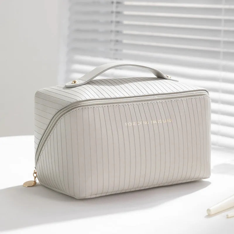 Vertical pattern cubic pillow makeup bag with 22.5 cm dimensions and PU construction