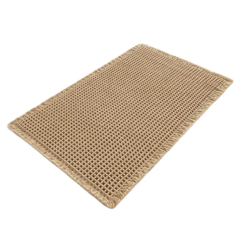 Square checkered pattern bathroom mat on tiled floor in a neutral beige colour.
