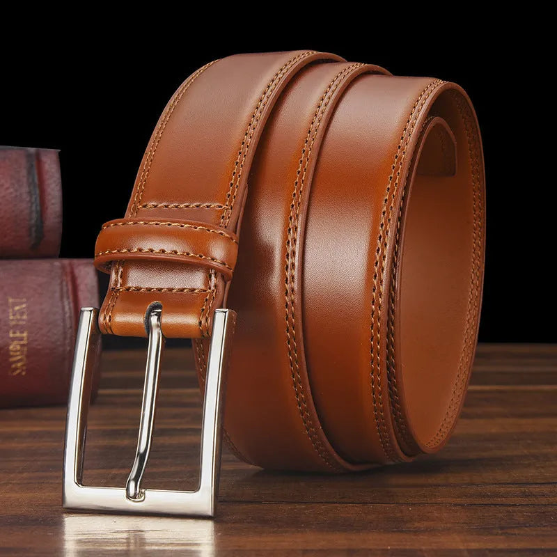 Men's black genuine leather belt with silver alloy pin buckle, showing adjustment holes and patent leather finish.