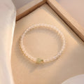 Natural Hetian Jade white agate women's bracelet 15cm on display showing banded white stones