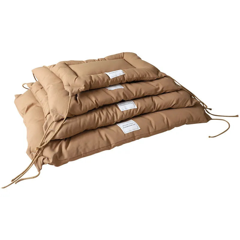 Beige cage cushion tied in a wire dog crate with soft padding for small pets