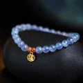 Natural ice translucent 8mm round crystal bead bracelet with sequin accents on display