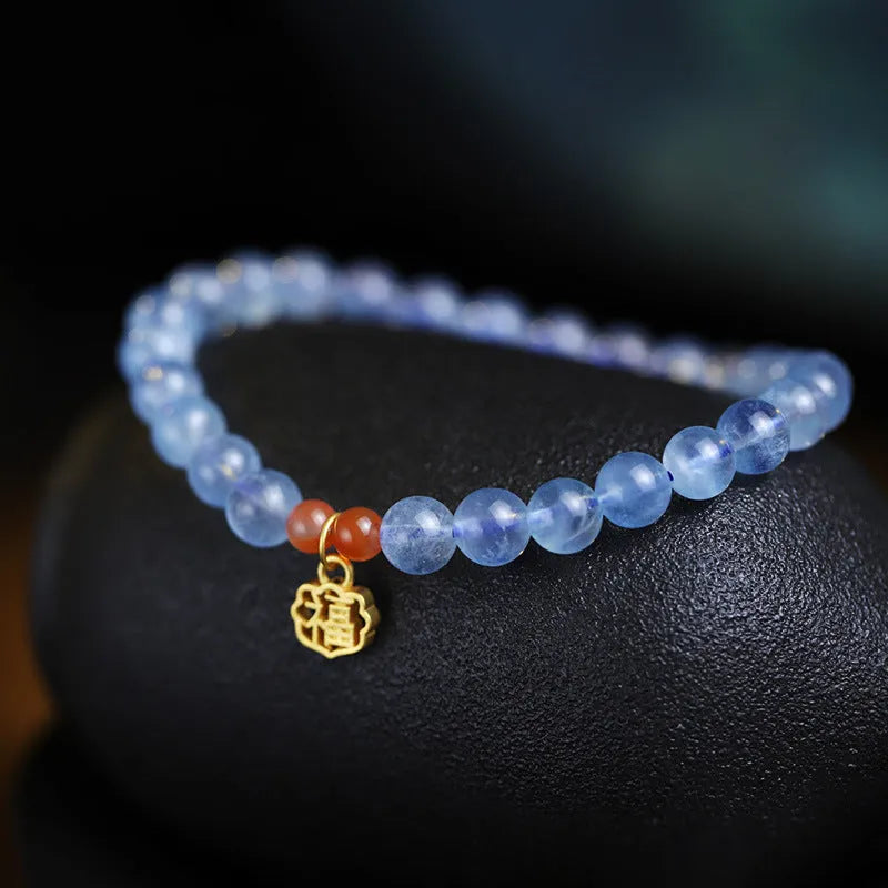 Natural ice translucent 8mm round crystal bead bracelet with sequin accents on display