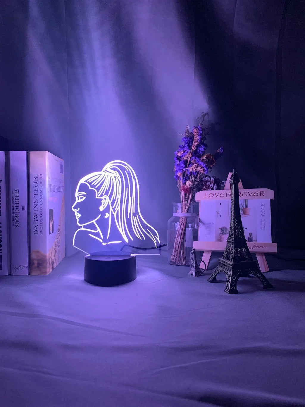 Slim European style acrylic 3D LED night light on a colourful black base, showing remote control.