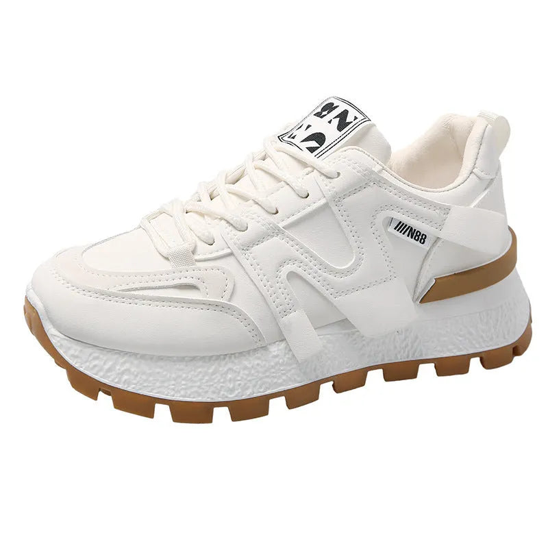 Low-top white and black casual sneakers with round toe and lace-up closure on a plain background.