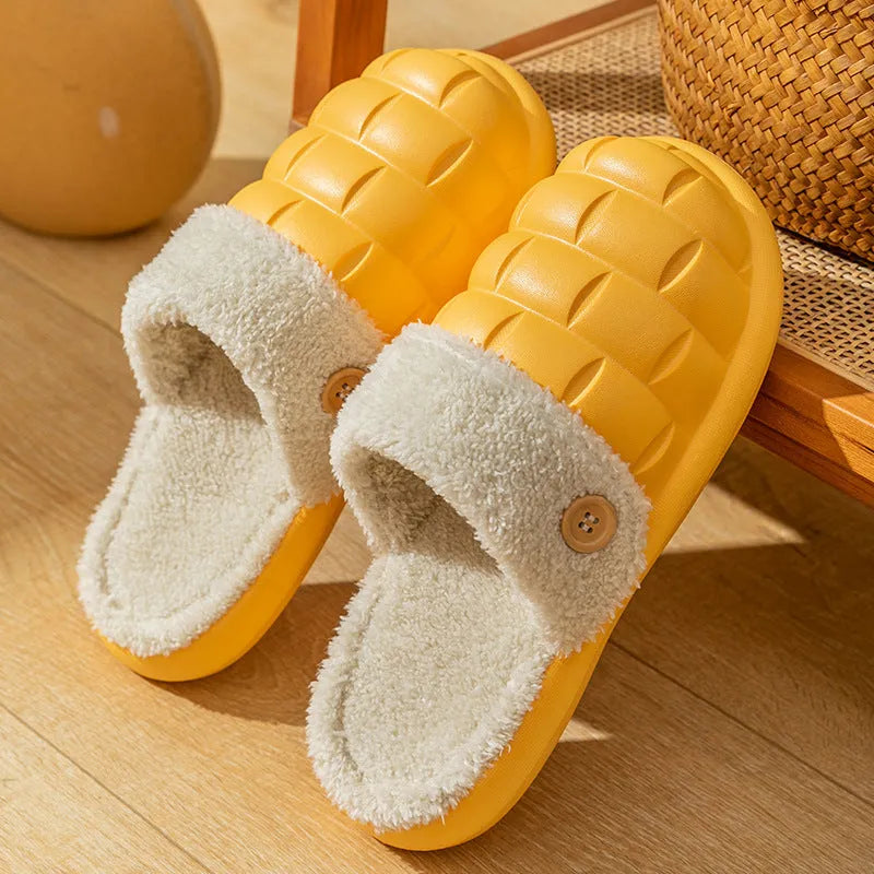 Women's pink and grey plaid EVA slippers with a detachable upper and plush lining on a wooden floor.