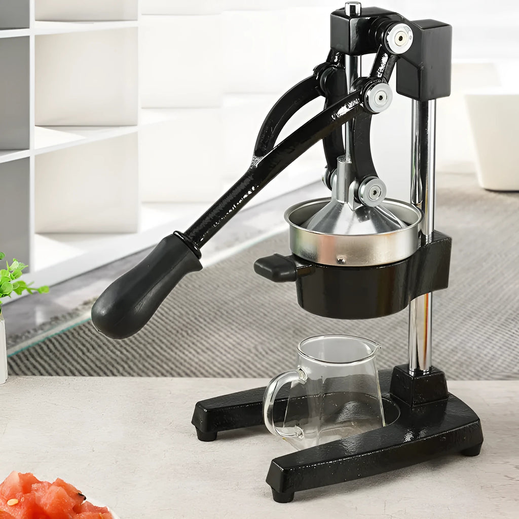 A black cast iron manual juicer with a stainless steel strainer, standing 40cm tall on a kitchen counter.