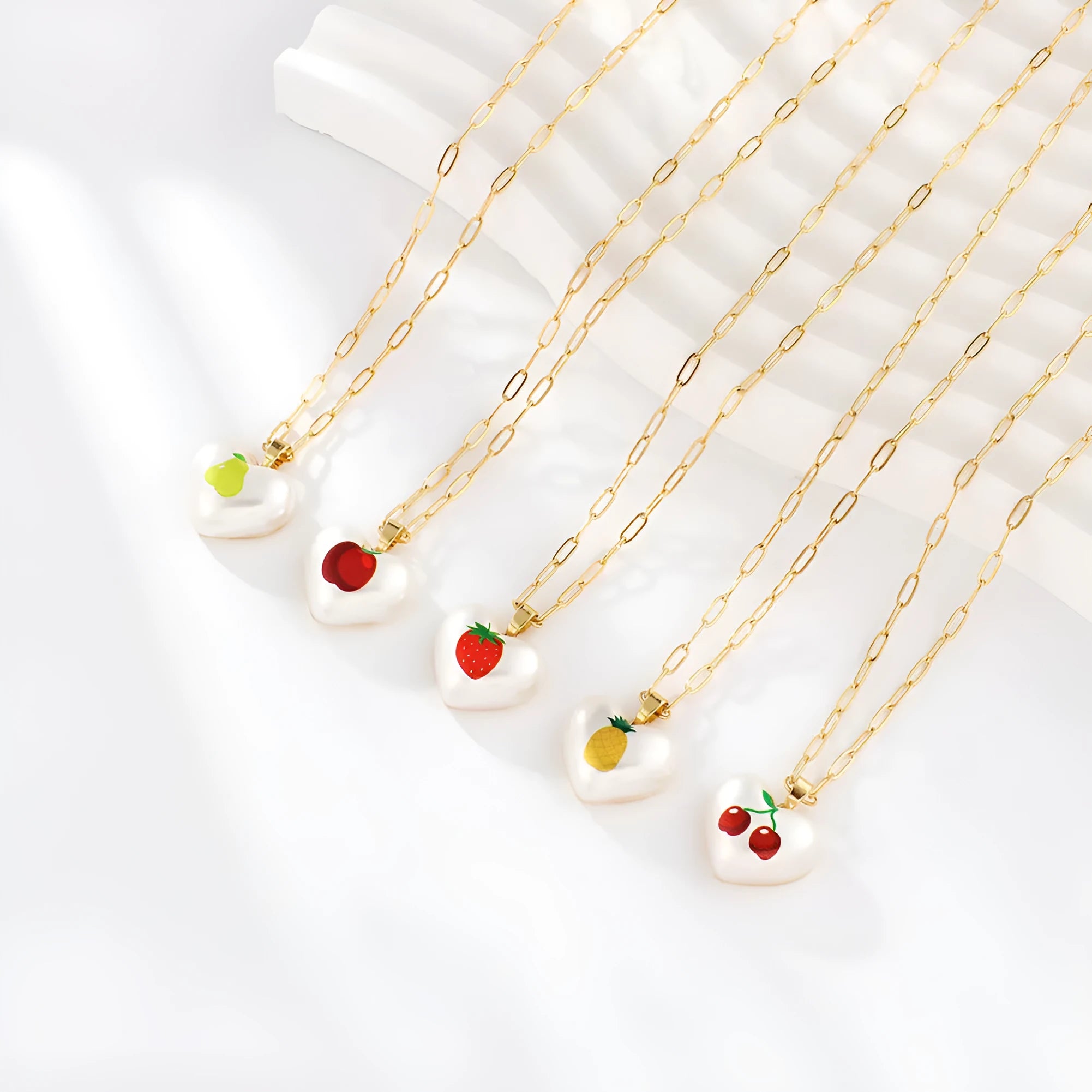 Heart-shaped fruit pendant necklace with strawberry design on adjustable metal chain