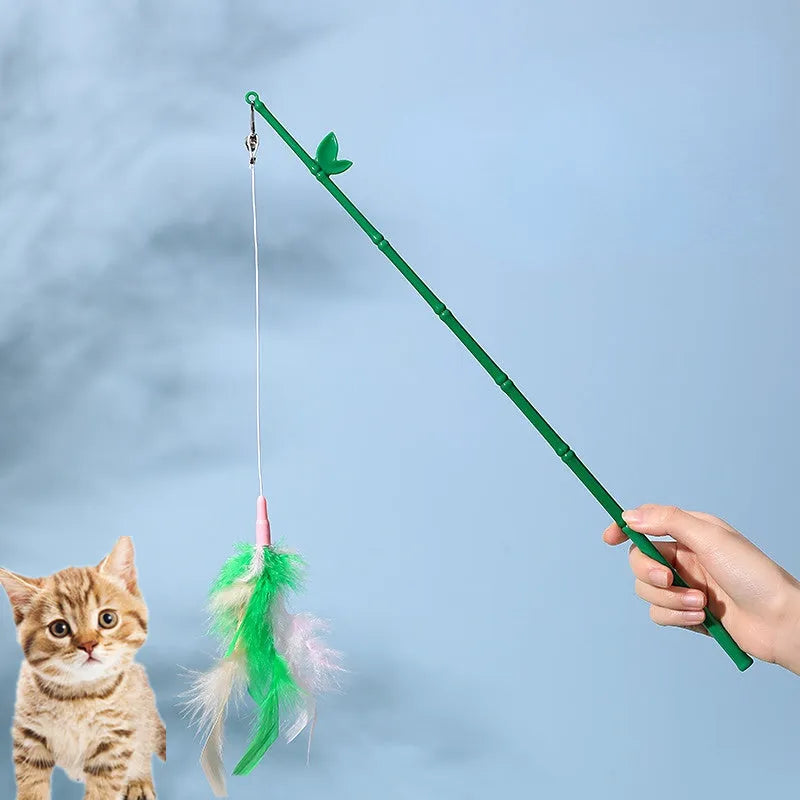 Green interactive cat toy feather wand with bell refills and feathers on a white background