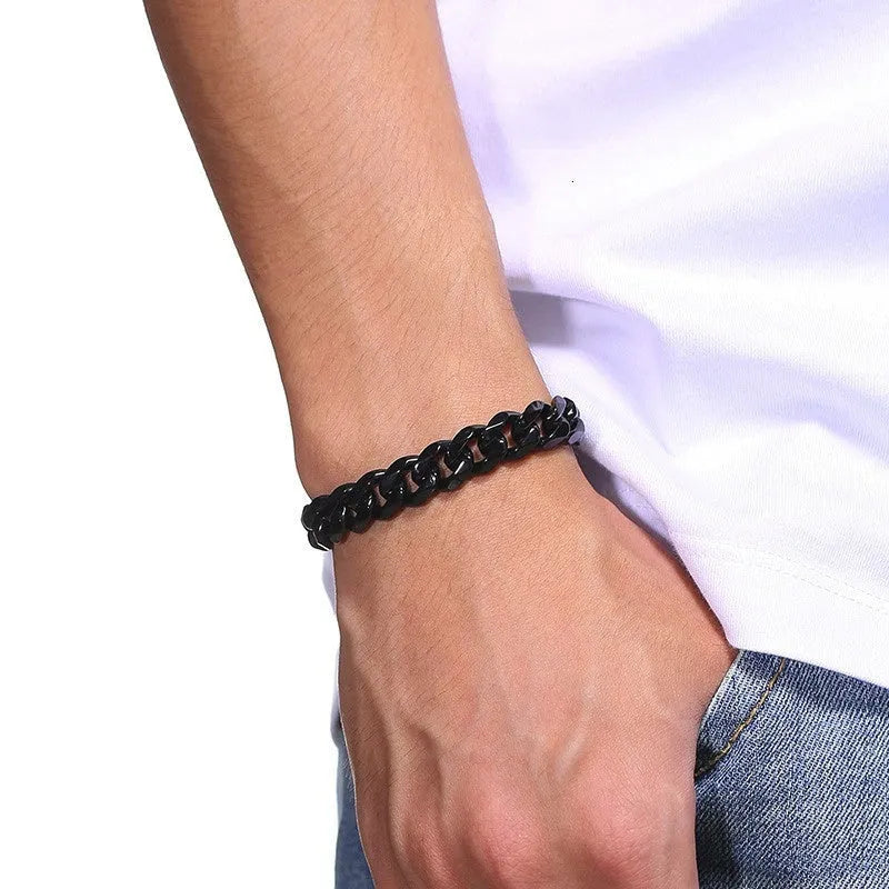 Six-sided geometric Cuban link chain metal bracelet in a gold finish on a wrist.