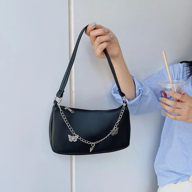 Black PU leather butterfly chain crossbody bag with a square shape and outer pocket.