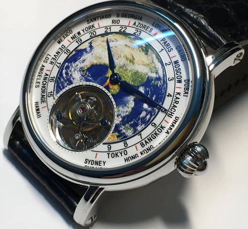 Silver 3D globe tourbillon mechanical watch with leather band and stainless steel case on white background