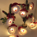 Snowman LED string lights garland with warm white glow on a Christmas tree