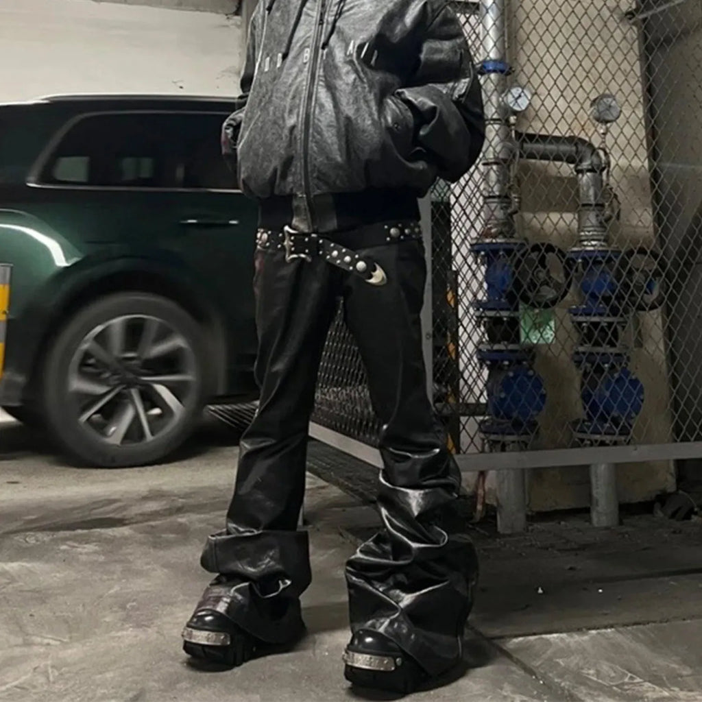 Black shiny patent leather straight-leg skinny jeans on a hanger