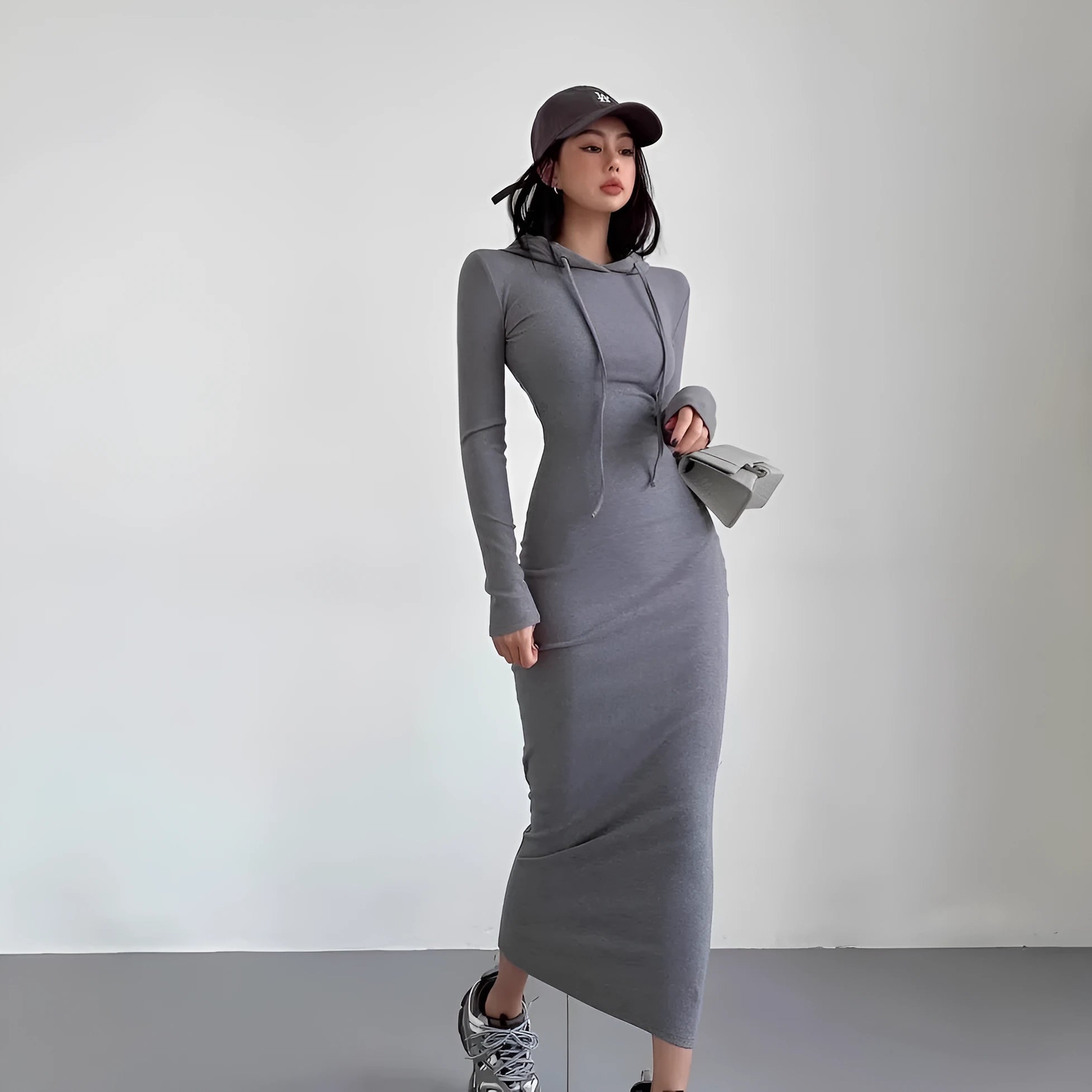 Women's grey hooded long-sleeve sheath dress with a high waist on a model