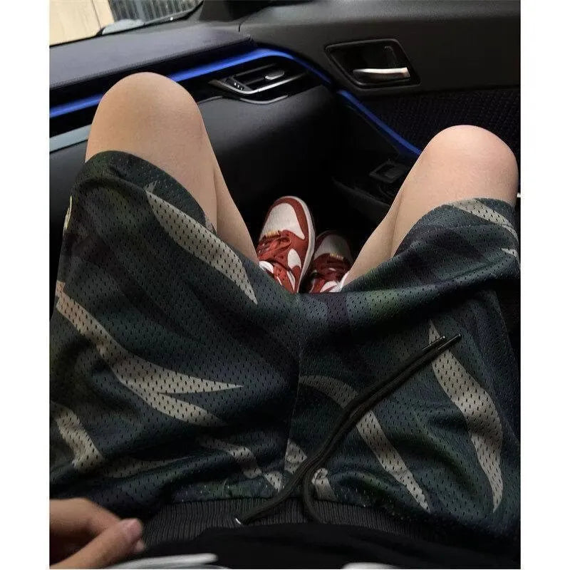 Men's straight-leg camouflage shorts in cotton blend fabric, showing the earthy pattern.