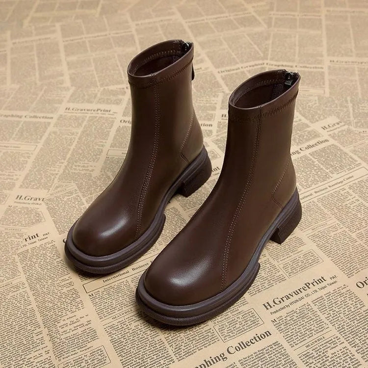 Women's black ankle boots with flat heel and rear zipper, round toe design