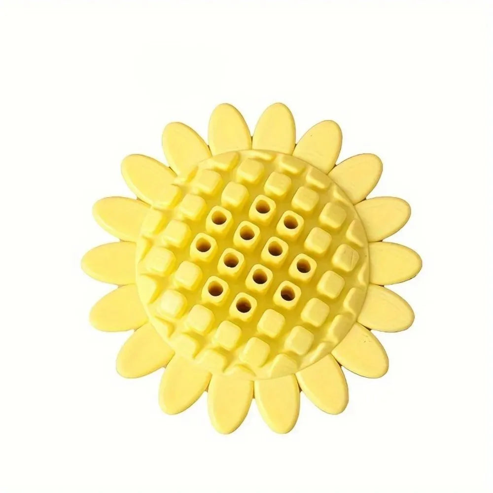 Yellow rubber sunflower dog chew toy on a surface, non toxic and BPA free for puppy teething