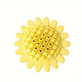 Yellow rubber sunflower dog chew toy on a surface, non toxic and BPA free for puppy teething