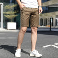 Men's loose elastic waist fifth pants in solid colour polyester, available in multiple colours including khaki and grey.