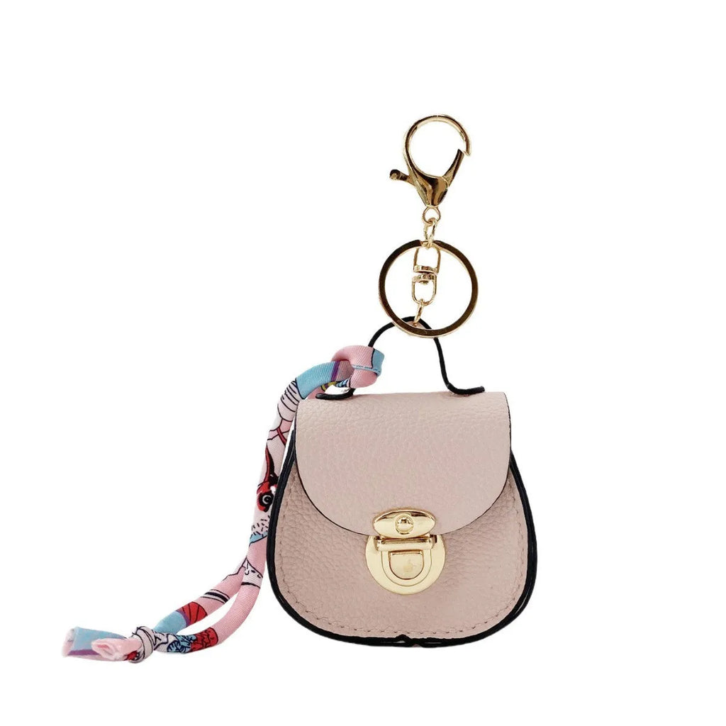 Small PVC coin purse pendant in solid colour with keychain attachment on white background