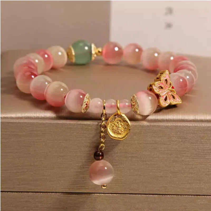 Pink opal butterfly women's bracelet with electroplated finish, Chinese style, on display