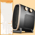 Small white electric heater fan with mechanical controls on a wooden floor
