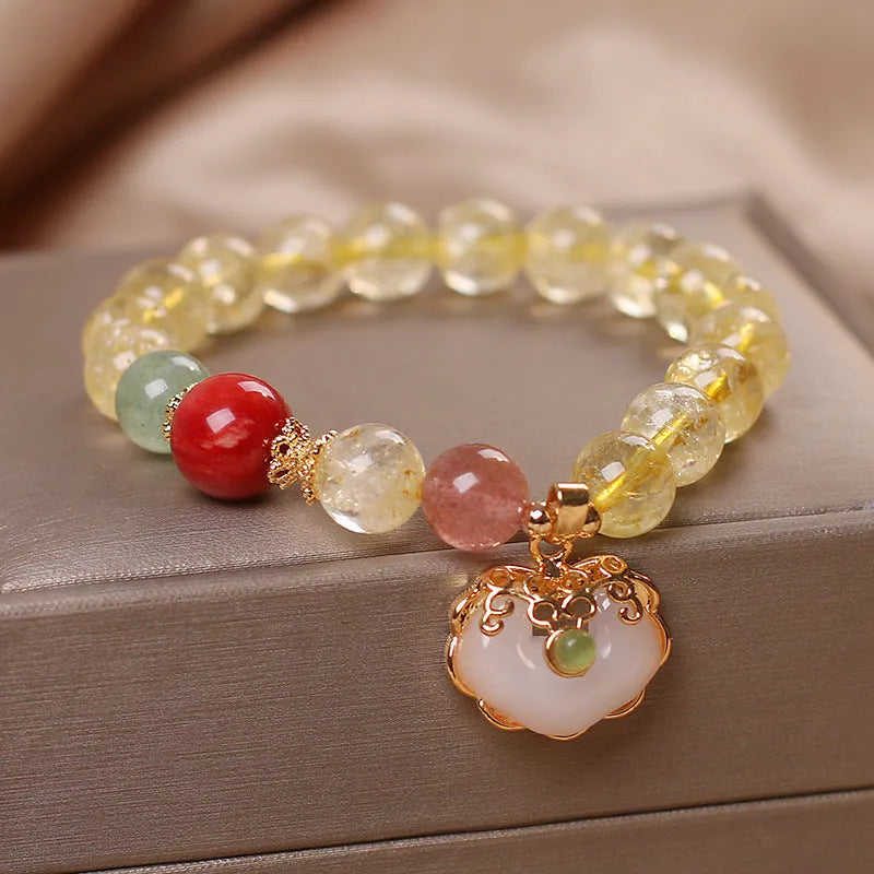Women's yellow hair crystal jade ruyi pendant bracelet on an alloy chain.