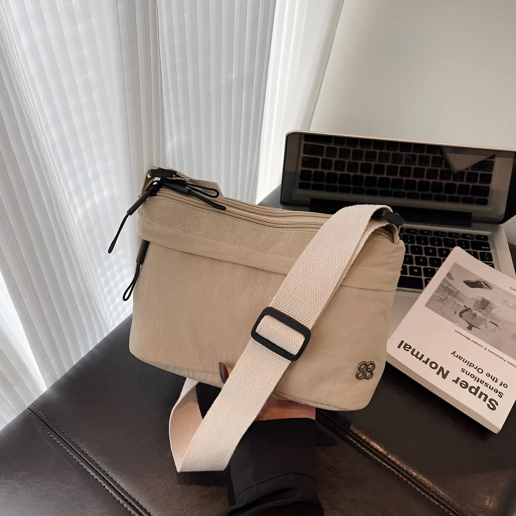 Lightweight cloth crossbody bag in black with horizontal square shape, sandwich pocket, and canvas lining
